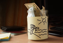 Jar Of Money For Travelling On The Table.  Travel Concept.
