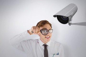 Poster - Geeky businessman looking through magnifying glass