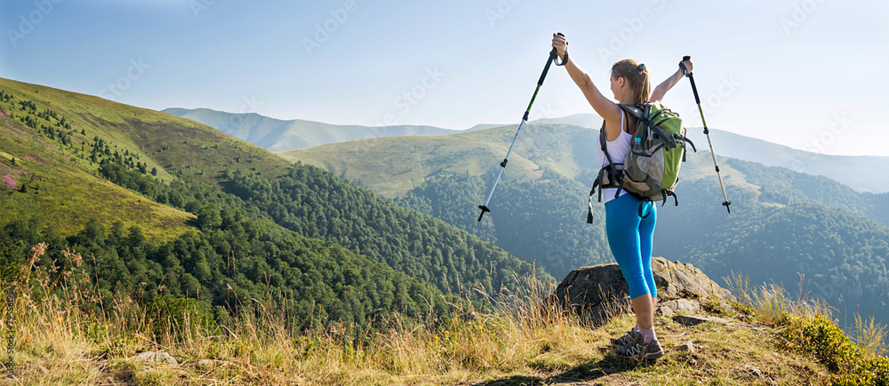 Young woman hiking in the mountains - obrazy, fototapety, plakaty 