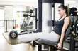 Woman at quadriceps exercise machine