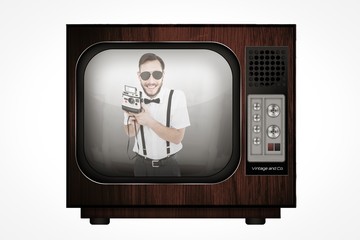 Poster - Composite image of geeky hipster holding a retro camera