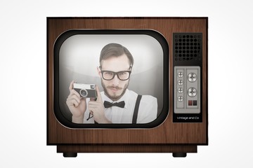 Poster - Composite image of geeky hipster holding a retro camera