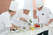 © goodluz - Chef training students in restaurant kitchen