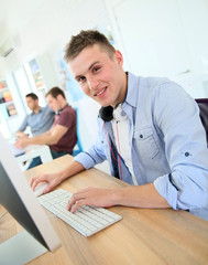 Aufkleber - Student working on computer in class