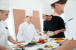 © goodluz - Chef training students in restaurant kitchen