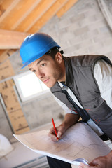 Wall Mural - Construction manager on site reading blueprint