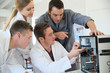 © goodluz - Students in computing class with teacher fixing hardware