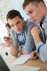 Aufkleber - Teacher with student working on desktop
