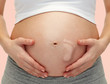 © Syda Productions - close up of pregnant woman touching her bare tummy