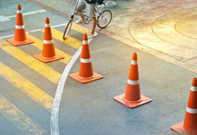 Abstract Colorful Traffic Cones And Bicycle Man On The Street