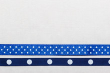 Dotted Blue Ribbon Frame On White Cloth