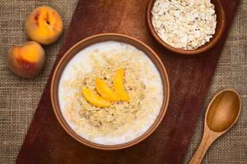 Canvas Print - Bowl of oatmeal porridge with peach slices
