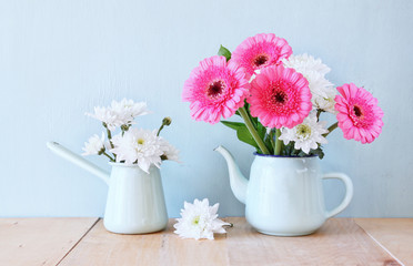 summer bouquet of flowers on the wooden table with mint backgrou