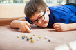 Kid playing with marbles