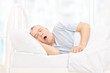 Mature man sleeping in a comfortable bed