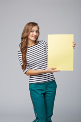 Full length of beautiful woman standing behind, holding white bl