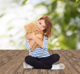 Wall Mural - cute little girl hugging teddy bear