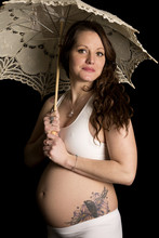 Pregnant Woman With A Tattoo Looking Holding An Umbrella