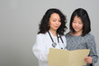 © acfrank - Female Doctor with female patient and medical chart