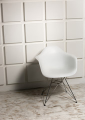 Poster - Modern white chair against bricked wall