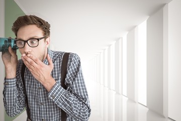 Poster - Composite image of geeky businessman eavesdropping with cup