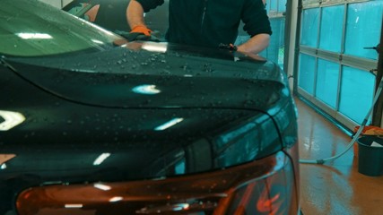 Poster - Worker wiping car on a car wash