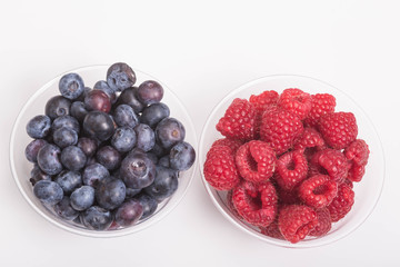 Wall Mural - Blueberries and Raspberries in Cups on White