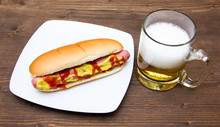 Beer And Hot Dogs On Wooden Table
