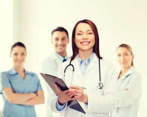 Poster - smiling female doctor with clipboard