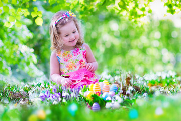 Wall Mural - Beautiful little girl at egg hunt