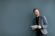 © BGStock72 - Man with tablet by the wall