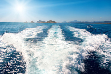 Wall Mural - Waves on blue sea behind the boat