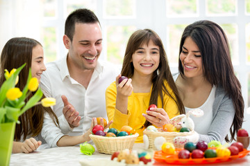 Happy family have fun with Easter eggs