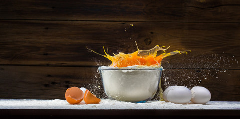 eggs and flour on a wooden background