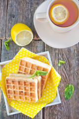 Canvas Print - tea with lemon and waffle