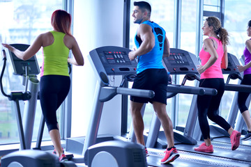 Wall Mural - Group of people running on treadmills