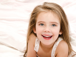 adorable smiling little girl waked up