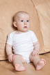 © TMakotra - portrait of the baby on a beige background