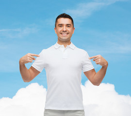 Poster - smiling man in t-shirt pointing fingers on himself