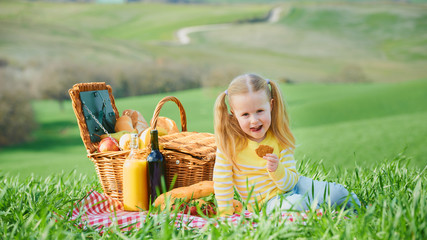 Beautiful smiling girl on green spring grass in the background l