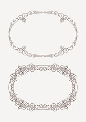 Fototapete - Pair of rich decorated calligraphic oval frames.