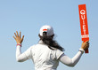 The lady volunteer shows the quite please sign in golf tournamen