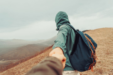 Traveler woman follows a man on nature