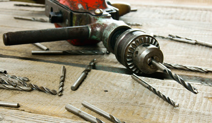 drill on wooden background.