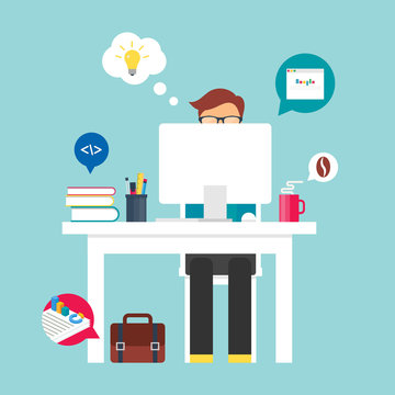 Man sitting at the table and working on the computer in the offi
