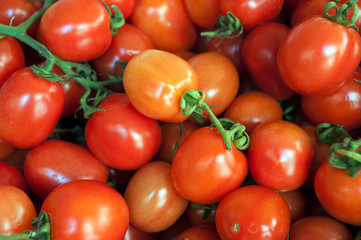 background of fresh vine tomatoes for sale on street market