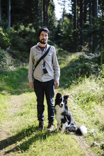 Germany, Hesse, Man With Border Collie On Forest Path