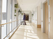 © Westend61 - Germany, Cologne, Senior woman with walking frame at corridor in nursing home