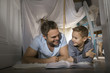 © Westend61 - Father and son having fun in self-made tent at home