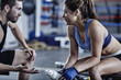 © Westend61 - Athlete with trainer in gym having a break
